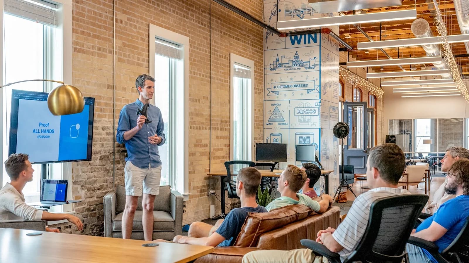 People collaborating in a bright office, comparing spreadsheet and software workflows